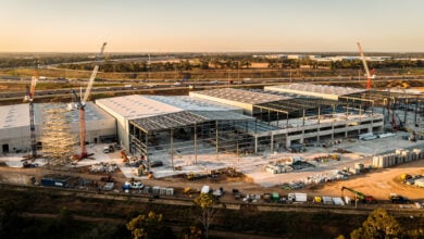 Aerial view of Western Sydney logistics estate under construction with M7 motorway in background