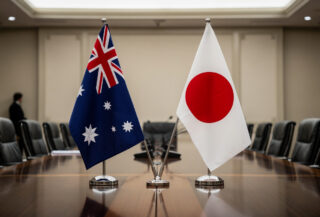 Australian and Japanese flags at diplomatic meeting table, Canberra