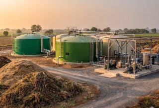 Biogas plant facility with digesters and compression equipment in rural Madhya Pradesh, India