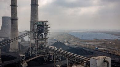 Coal power plant with solar panels in background, northern India industrial landscape