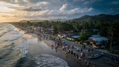 Coastal residents evacuating inland from Mindanao beach at dawn