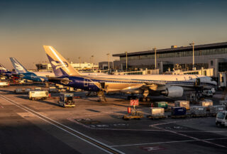 Commercial aircraft parked at international airport gates during busy operations
