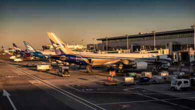 Commercial aircraft parked at international airport gates during busy operations