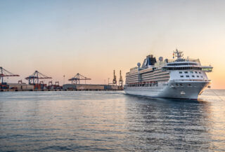 Cruise ship departing Mediterranean port at dawn, Eastern Mediterranean Sea
