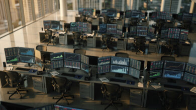 Currency trading floor with exchange rate displays and oil price charts, Kuala Lumpur