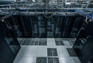 Data center server room with GPU clusters and cooling systems, blue and green lighting
