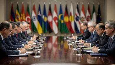 Defence ministers at formal conference table, Singapore, flags of Asian nations in background