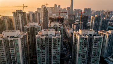 Dense high-rise residential towers in Asian city skyline at golden hour