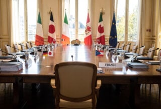 Empty chair at G7 summit table, Versailles, France