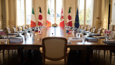 Empty chair at G7 summit table, Versailles, France