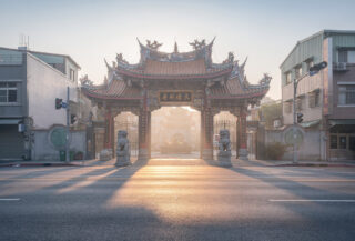 Empty Taipei temple entrance at dawn, minimal crowds, soft morning light