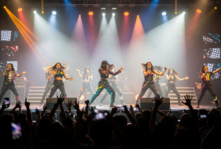 Filipino pop idols performing on concert stage with dramatic lighting and choreography