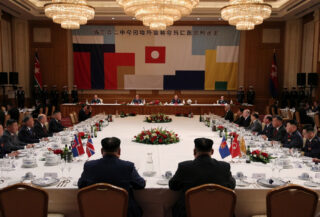 Formal state dinner setting in Pyongyang with diplomatic protocol and treaty anniversary backdrop