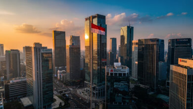 Jakarta financial district skyline at dusk with banking headquarters and Indonesian flag