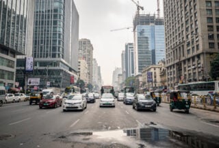 Mumbai financial district with modern office buildings and traffic under overcast light