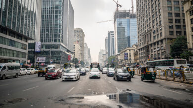 Mumbai financial district with modern office buildings and traffic under overcast light