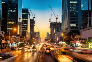 New Delhi financial district at dusk with office towers and construction cranes