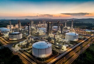 Petronas Chemicals refinery complex, Malaysia, industrial pipelines and storage tanks at dusk