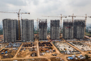 Residential construction site with cranes and apartment towers under development, Mumbai or Bangalore