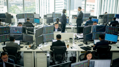 Singapore financial district trading floor with currency screens and Asian exchange rates displayed