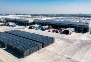 Solar panel manufacturing facility with stacked modules and export containers