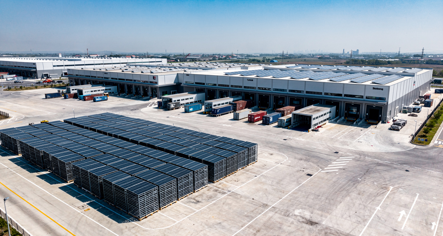 Solar panel manufacturing facility with stacked modules and export containers