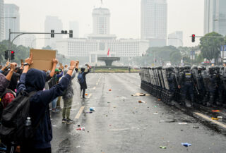 Student protesters at Hotel Indonesia traffic circle, Jakarta, facing police and military security
