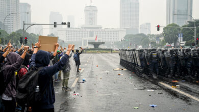 Student protesters at Hotel Indonesia traffic circle, Jakarta, facing police and military security