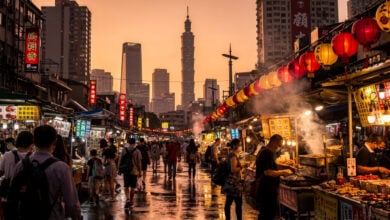 Taipei night market at golden hour with tourists shopping among illuminated stalls
