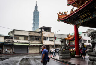 Taipei street temple with sparse daytime crowds, overcast light, quiet weekday atmosphere