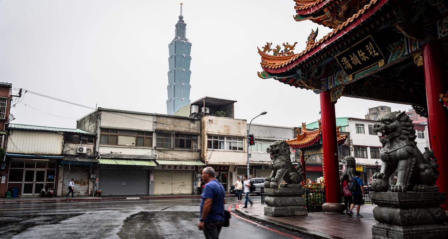 Taipei street temple with sparse daytime crowds, overcast light, quiet weekday atmosphere
