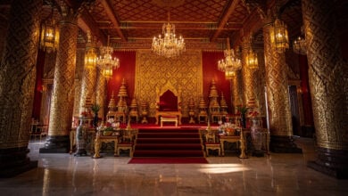 Thai royal palace formal ceremonial hall with ornate gold decoration and empty throne