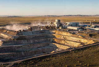 Uranium mining facility in Kazakhstan steppe with processing equipment and open pit