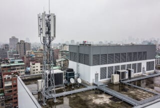 5G network infrastructure tower overlooking Taipei urban landscape, Taiwan