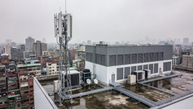 5G network infrastructure tower overlooking Taipei urban landscape, Taiwan