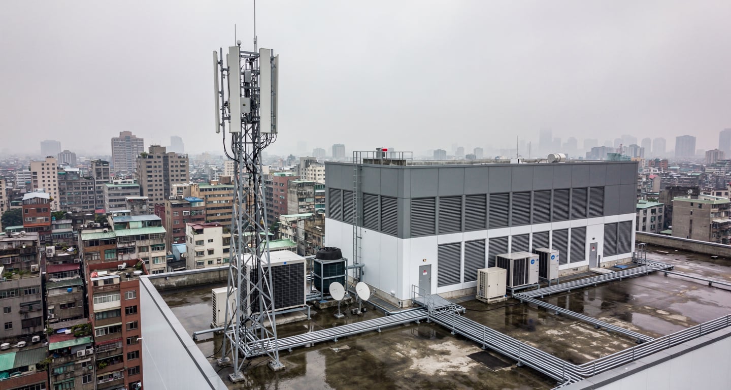 5G network infrastructure tower overlooking Taipei urban landscape, Taiwan