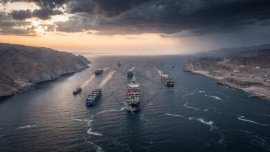 Aerial view of Strait of Hormuz with tanker ships transiting narrow waterway between Iran and Oman