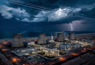 Bushehr nuclear power plant on Persian Gulf coast with military aircraft overhead