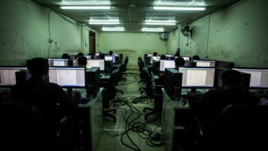 Call centre workstations in dim fluorescent light, Myanmar-Thailand border region