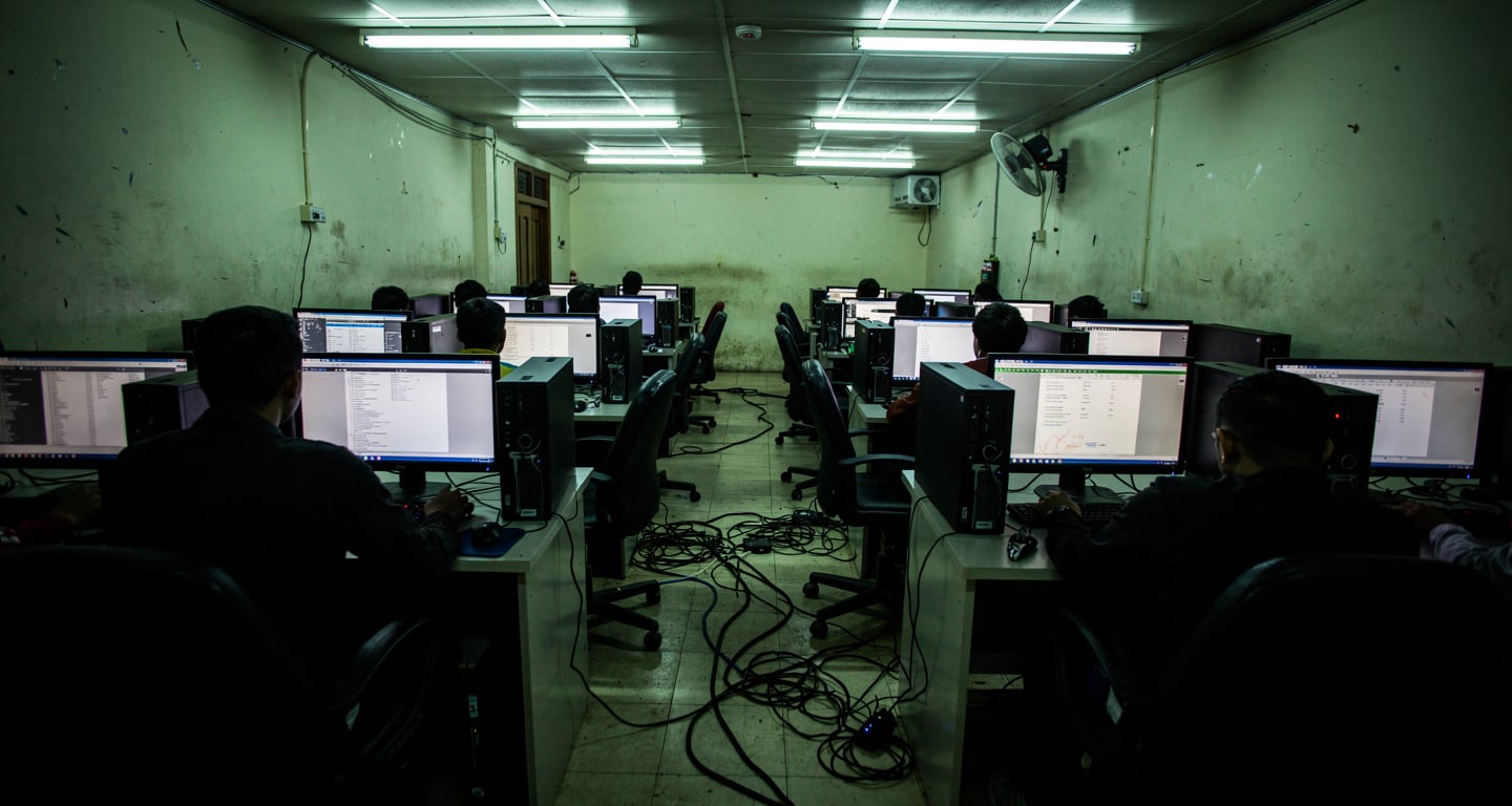 Call centre workstations in dim fluorescent light, Myanmar-Thailand border region