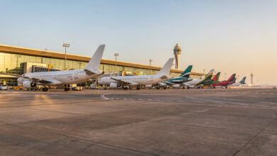 Commercial aircraft at Dubai International Airport terminal under morning light