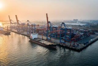 Container port at dawn, Bay of Bengal, Myanmar coast, industrial shipping infrastructure