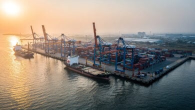 Container port at dawn, Bay of Bengal, Myanmar coast, industrial shipping infrastructure