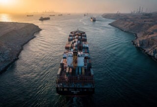 Container ship transiting narrow strait, Strait of Hormuz, Persian Gulf