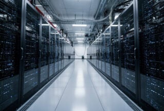 Data center interior with GPU server racks under blue LED lighting, Tokyo