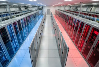Data center server racks with blue and red lighting symbolizing US-China AI competition