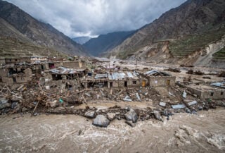 Destroyed buildings and debris in flooded mountain valley, Nuristan province, Afghanistan