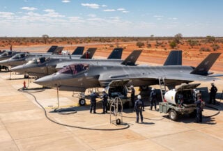 F-35A fighters on tarmac at RAAF Base Tindal with multinational ground crews performing joint maintenance