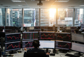 Financial trading floor with red market indices on screens, Seoul financial district