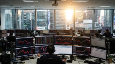 Financial trading floor with red market indices on screens, Seoul financial district